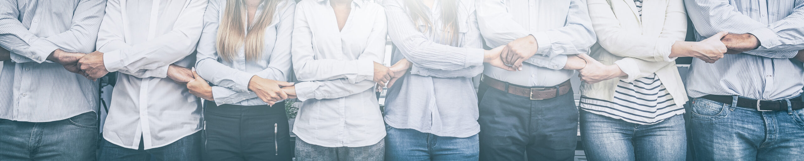 Creative team meeting hands together in line. Young business people are holding hands. Unity and teamwork concept.